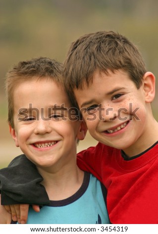Two Brothers smiling with their arms around each other
