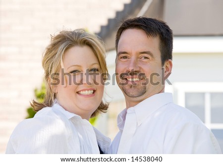 Happy Couple in Front of Their Home