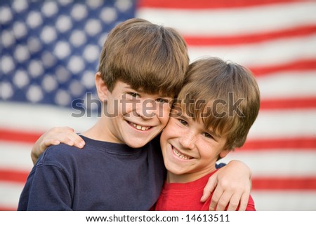 Brothers Hugging in Front of Flag