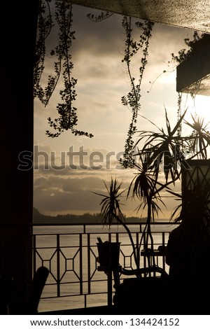 Silhouette of a table and wine bucket in a tropical location at sunset