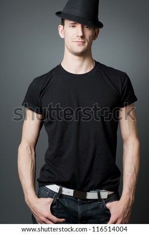 Young handsome tall guy posing in black t-shirt.