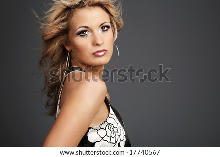 Beautiful young woman with hair on wind.