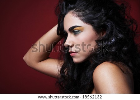 stock photo : Black hair fashion model posing on red background.