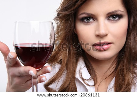 Pretty young brunette enjoying red wine