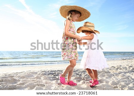 stock photo Two small girls dancing at the sunny beach