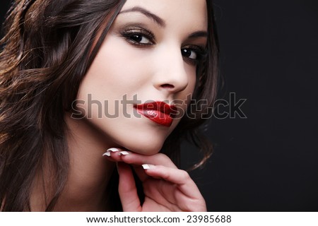 Portrait of beautiful young woman on black background.