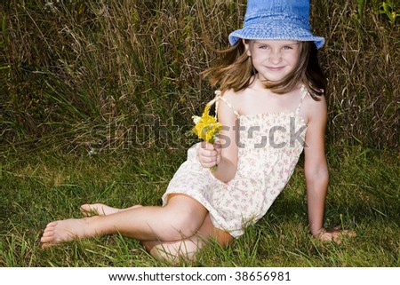 Little girl in short dress enjoys warm fall day.
