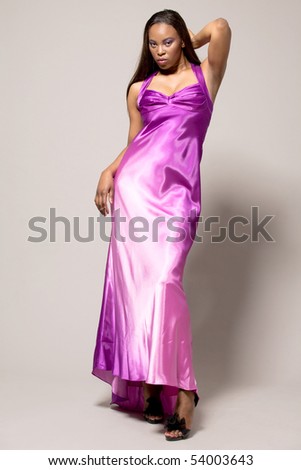 Happy attractive african-american fashion model in purple dress.