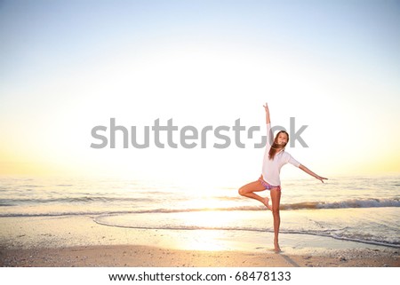 Young girl enjoys summer day at the beach.