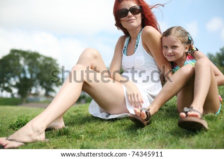 Happy mother and daughter enjoy hot summer day.