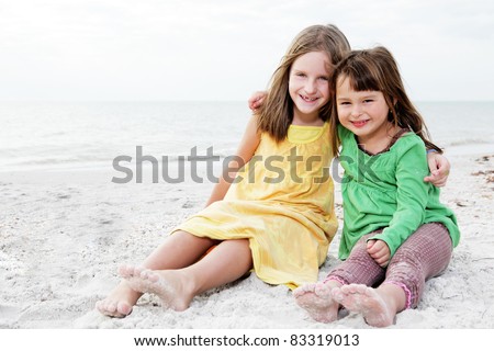 Young happy family enjoy summer day at the beach.
