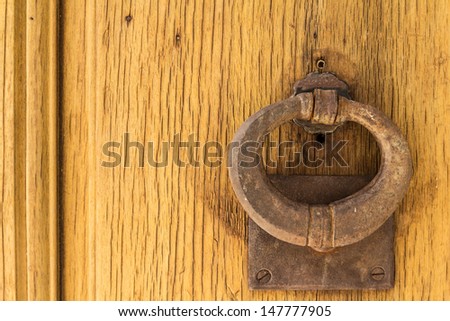 Door knock on a yellow wooden door