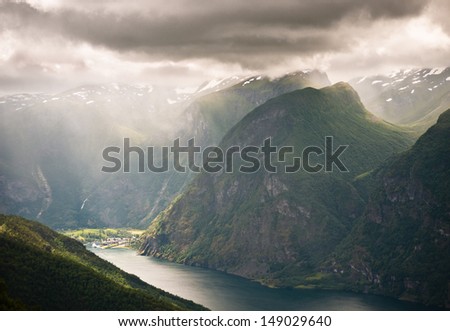 Flaam in Norway situated in end of inner Aurlandsfjord during an overcast day with rain and sun