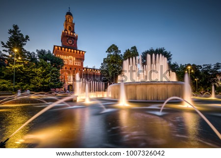 Sforza Castel (Castello Sforzesco) with the fountain at night, Milan, Italy. This castle was built in the 15th century by Sforza, Duke of Milan. It is one of the main tourist attractions of Milan.