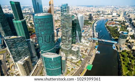Aerial panoramic view of Moscow with Moskva River in summer, Russia. Panorama of Moscow in the sunlight. Modern skyscrapers of Moscow-City. Landscape and cityscape of Moscow. The city from above.