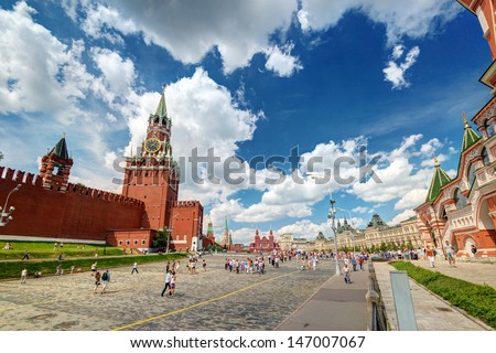 MOSCOW - JULY 13: Tourists visiting the Red Square on july 13, 2013 in Moscow, Russia. The Red Square and the Kremlin are the main attractions in Moscow.