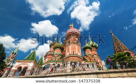 MOSCOW - JULY 13: Tourists visiting the St. Basil\'s Cathedral on july 13, 2013 in Moscow, Russia. St. Basil\'s Cathedral is a famous monument of Russian culture of the 16th century.