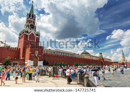 MOSCOW - JULY 13: Tourists visiting the Red Square on july 13, 2013 in Moscow, Russia. The Kremlin is the main attraction of the Red Square.