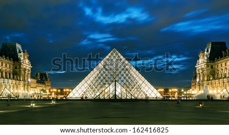 PARIS - SEPTEMBER 25: Louvre museum at night on september 25, 2013 in Paris. The Louvre is one of the largest museums in the world and one of the major tourist attractions of Paris.