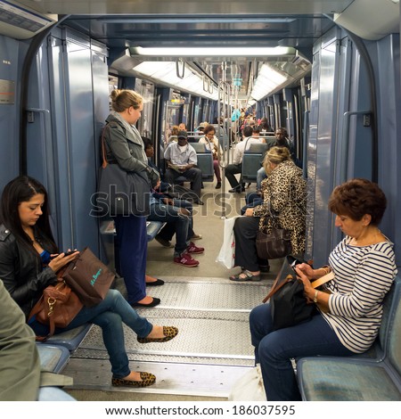 PARIS - SEPTEMBER 24: People are in a subway car on september 24, 2013 in Paris, France. The Paris metro is clean, fast and safe form of transport.