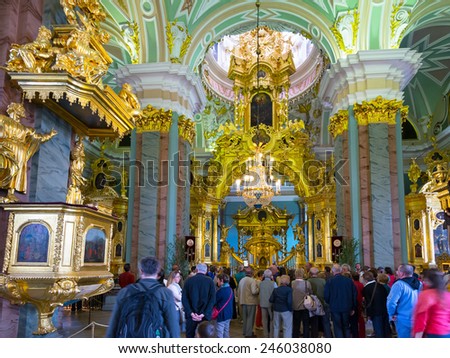 ST PETERSBURG, RUSSIA - JUNE 13, 2014: Tourists visit the Peter and Paul Cathedral. Russian emperors are buried here.