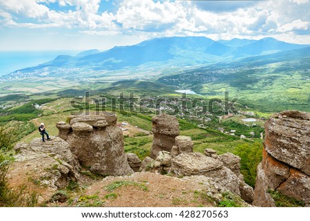 Tourist on the formation of the Demerdji mountain. Landscape of Crimea, Russia.