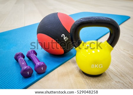 Mat for fitness classes with dumbbells, weight and ball