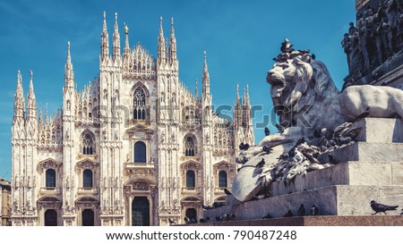 Panoramic view of Piazza del Duomo with sculpture of a lion in summer, Milan, Italy. The Milan Cathedral (Duomo di Milano) in the background. Milan Cathedral is the main tourist attraction of Milan.