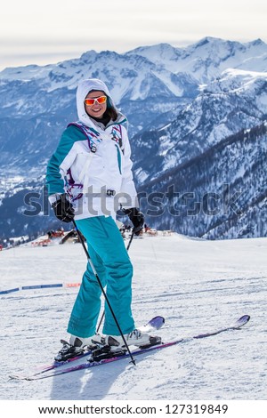 Happy smiling girl in ski. Focus on the girl