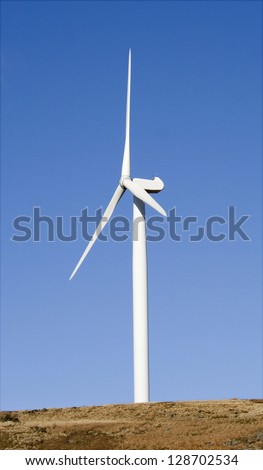 Green Energy. Wind Turbine on pure blue sky in Scottish moorland