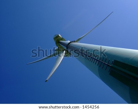 Unusual angle on a wind turbine against a deep blue sky