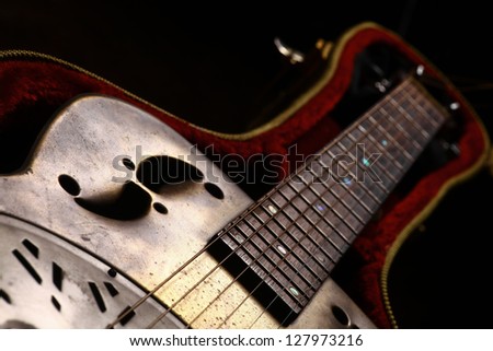 Color shot of a vintage guitar in a case