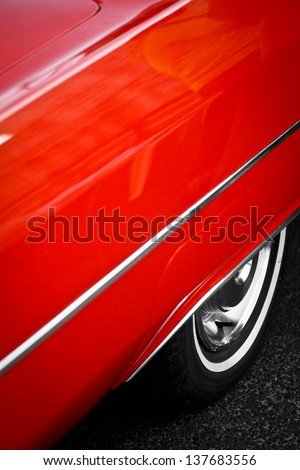 Color detail of the back wheel of a vintage red car