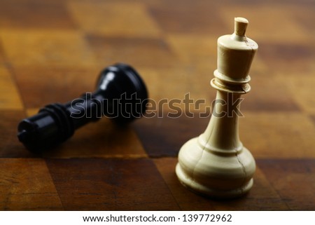 A black king and a white one on a chess board