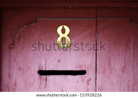 Color shot of a mail slot in an old door.