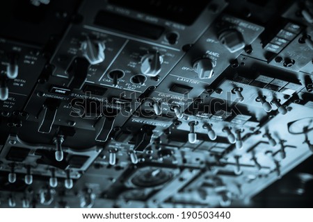 The pilots\' control panel inside a passenger airplane.