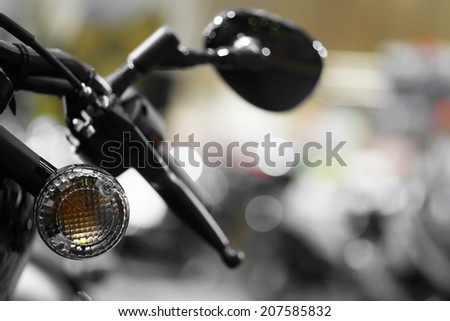 Detail with the lever and turn signal of a motorcycle.