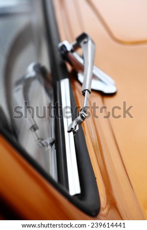 Color vertical shot of a vintage car screen wiper.