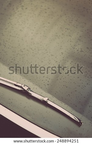 Color vertical shot of a vintage car screen wiper.