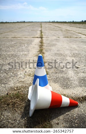 Two cones, red and blue, on the road.