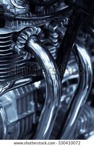 Detail of a motorcycle exhaust pipes and cylinders..