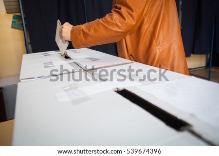 A person casts her ballot during voting for parliamentary elections at a polling station in Bucharest, Romania.