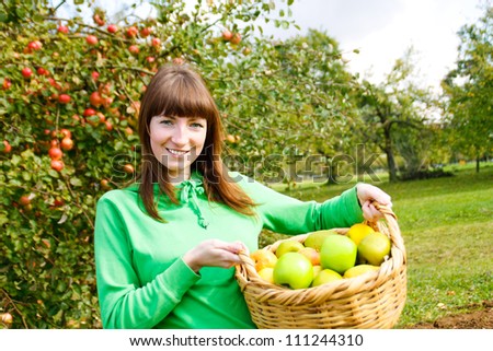 Young woman in apples garden