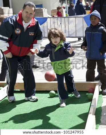 NEW YORK - APRIL 28: Unidentified kids play oversize bocce at Family festival during the 2012 Tribeca Film festival on Greenwich street on April 28, 2012 in New York City