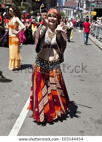 NEW YORK - MAY 19: Member of Andrea Belly dance group performs with sword on Broadway as part of New York Dance Parade on May 19, 2012 in New York City