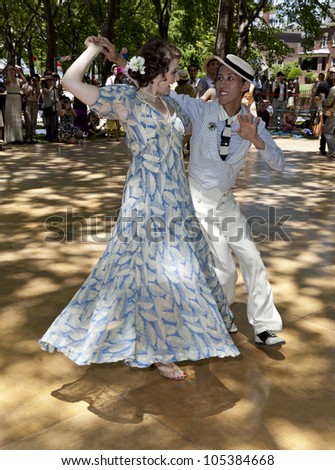 NEW YORK - JUNE 16: Voon Wai and partner dances at 7th Annual Jazz age concert and picnic on Governors Island on June 16 2012 in New York