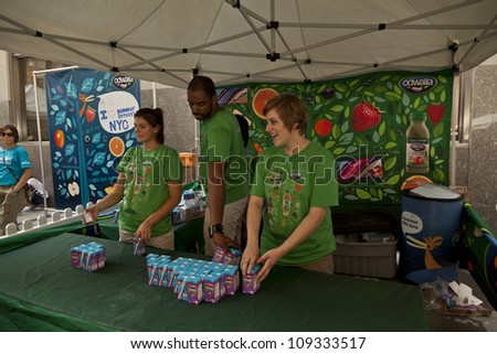 NEW YORK - AUGUST 04: Sales representatives of Odwalla give juice sample at picnic area sponsored by Whole Foods during Summer Streets sponsored by DOT on Park Avenue in Manhattan on Aug 4 2012 in NYC