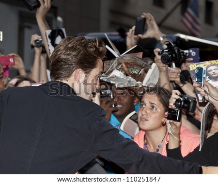 NEW YORK - AUGUST 15: Actor Rob Pattison greets fans outside ABC TV station on Times Square after appearance on Good Morning America show in Manhattan on August 15, 2012 in NYC