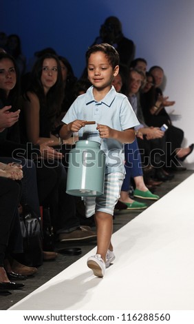 NEW YORK - OCTOBER 20: Boy model walks runway for petite Parade show collection by Zutano during kids fashion week NYC sponsored by Vogue Bambini at Industria Supertudio on October 20, 2012 in NYC