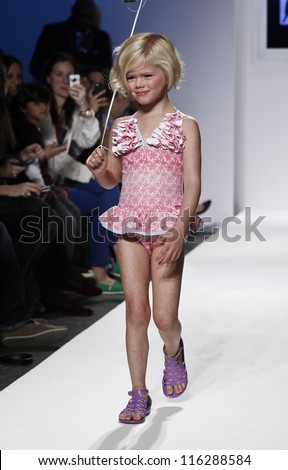 NEW YORK - OCTOBER 20: Girl model walks runway for petite Parade show collection by Floatimini during kids fashion week NYC sponsored by Vogue Bambini at Industria Supertudio on October 20 2012 in NYC